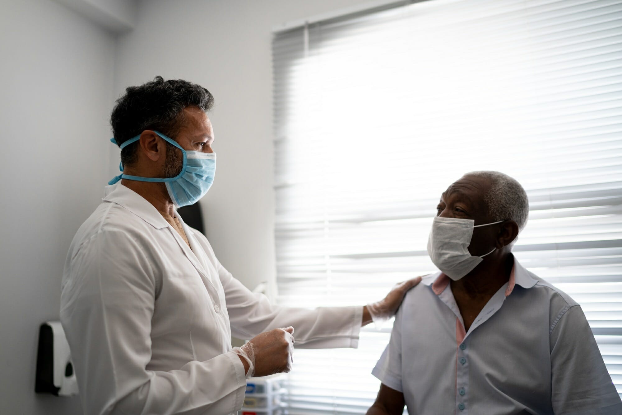 doctor with older Black patient wearing mask