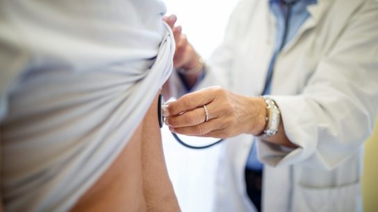 doctor administering physical exam