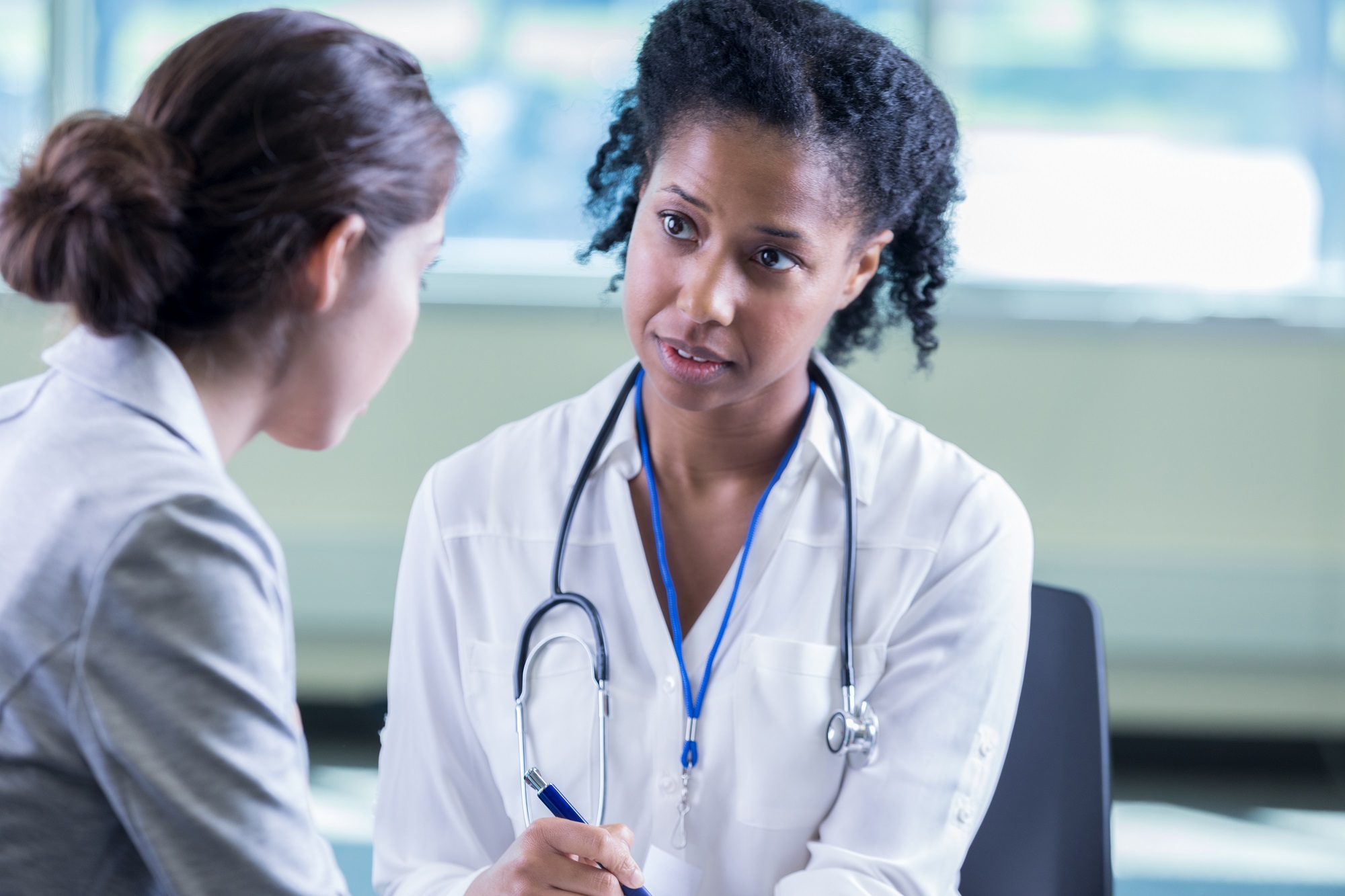 Doctor compassionately listens to female patient