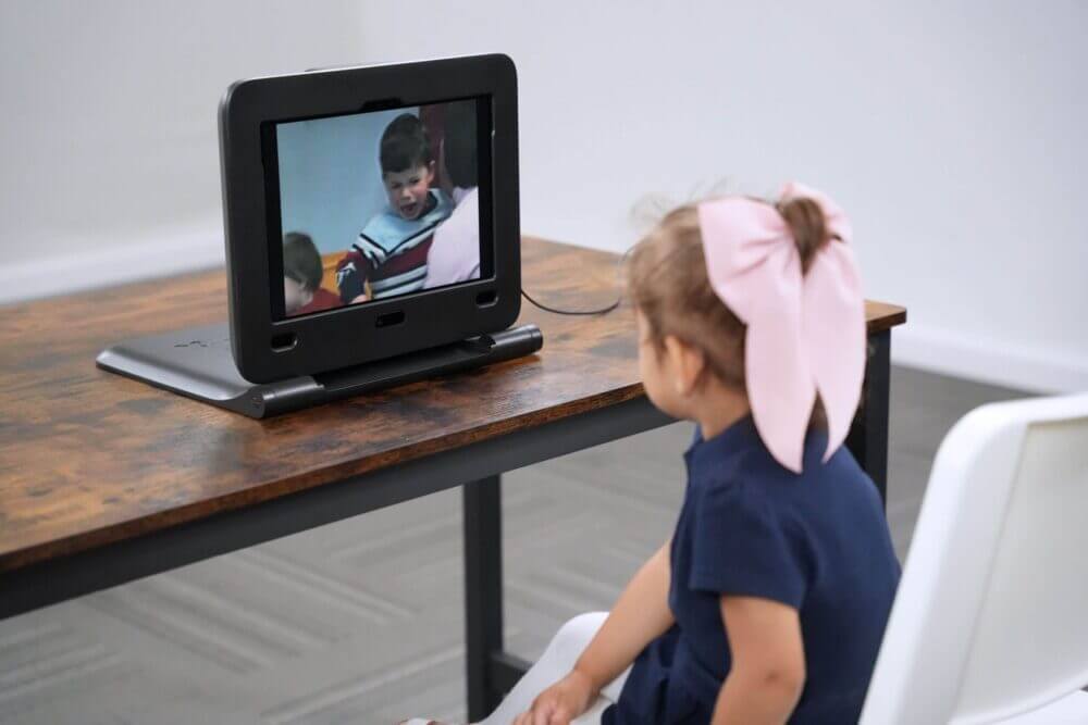 Young-girl-sitting-at-a-desk-looking-at-digital-screen.