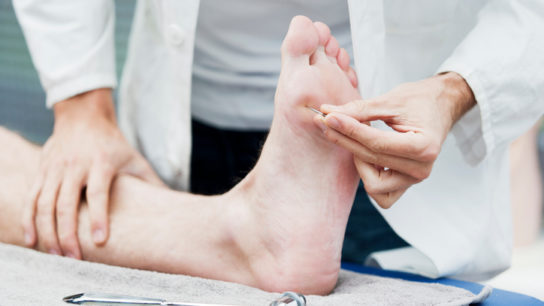 dr checking foot sensitivity