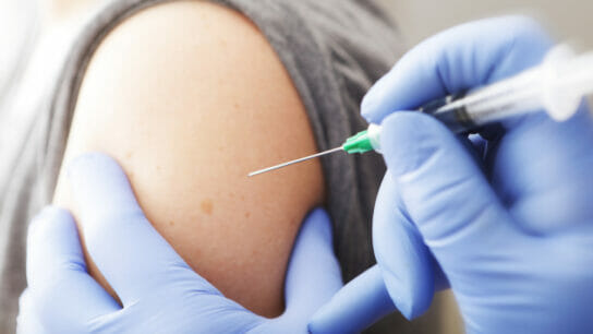 A-closeup-of-woman-receiving-vaccination-from-physician.