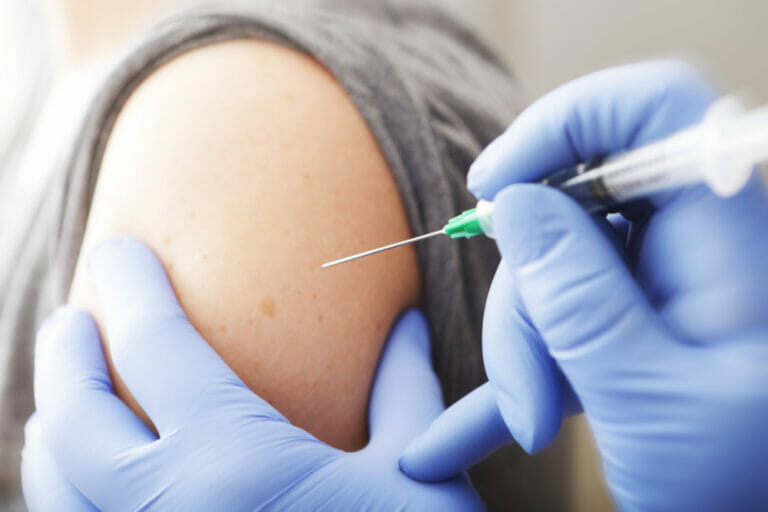 A-closeup-of-woman-receiving-vaccination-from-physician.