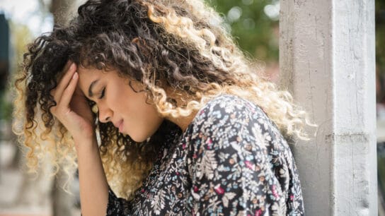 woman rubbing forehead