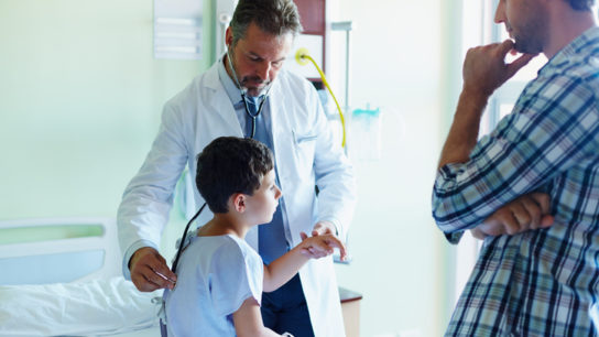 little boy being examined in hospital
