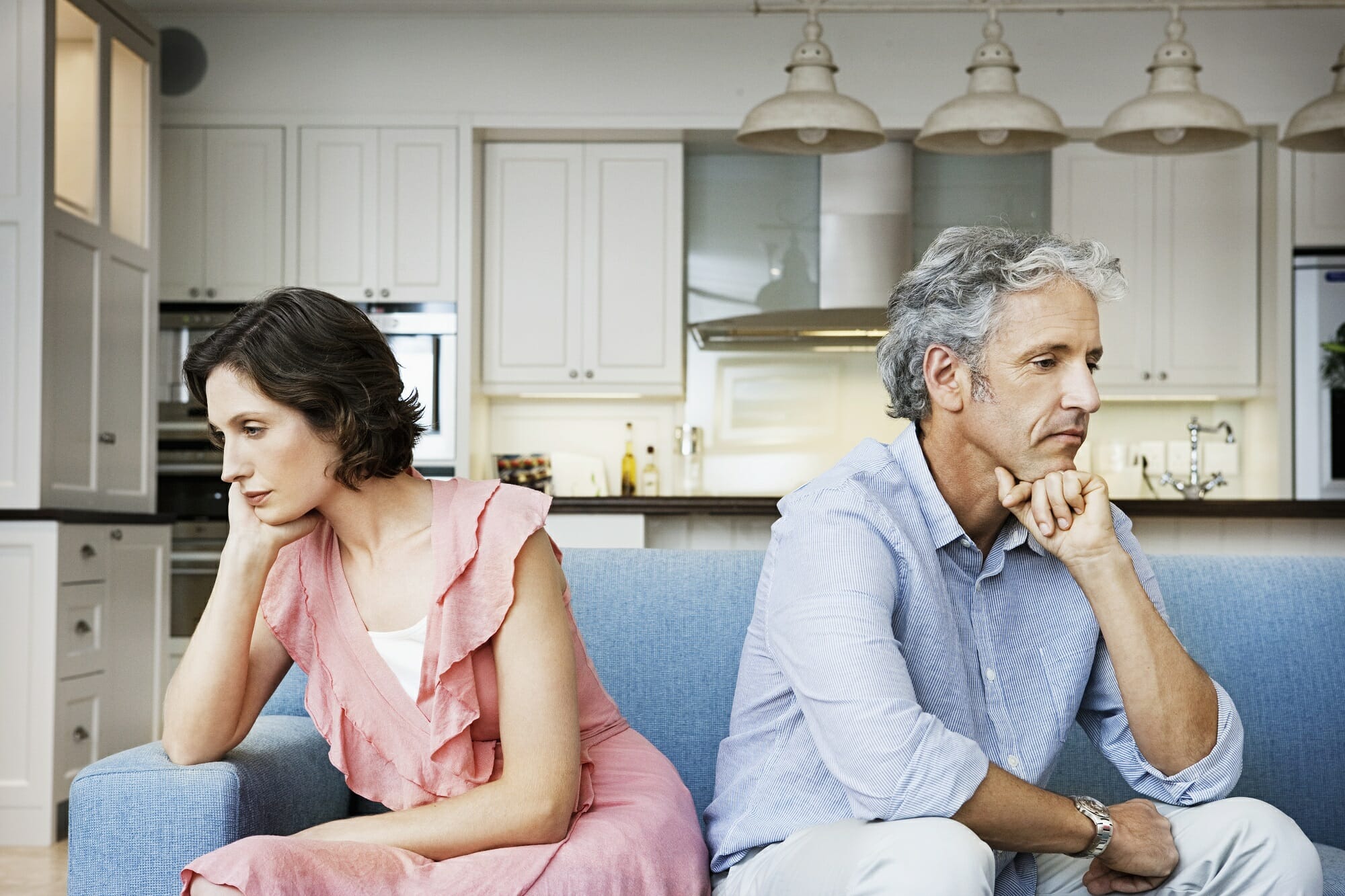 man and woman sitting back to back