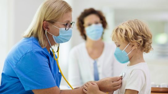 pediatrician examining pediatric patient